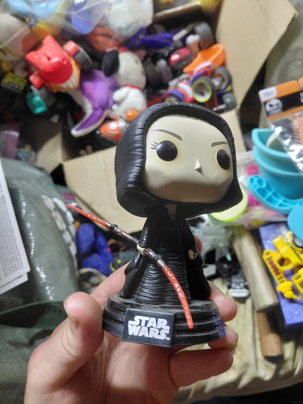 collectible vinyl figure of Dark Rey holding a red hinged lightsaber from Star W
